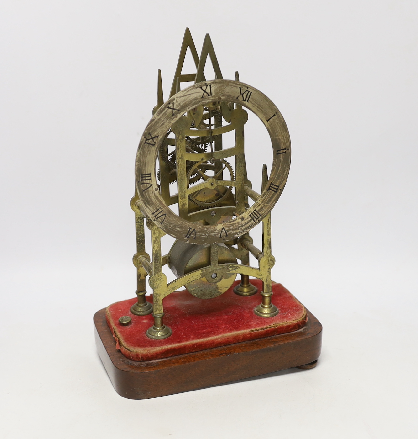 A skeleton clock with Roman numeral dial, on wooden base, 33cm high